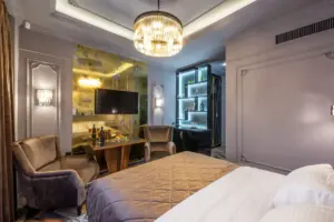 A hotel room with a table, glasses and a window view